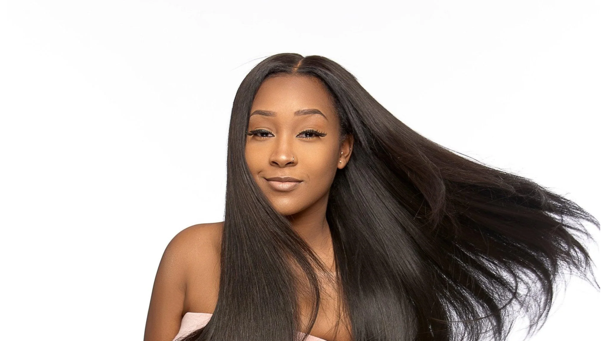 Burmese Raw Straight hair in natural black, styled long and sleek with visible movement and a smooth straight texture.