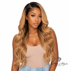 Honey blonde Swiss HD lace wig by Her Hair Company, showcasing natural hairline and silky, layered wig on a model.