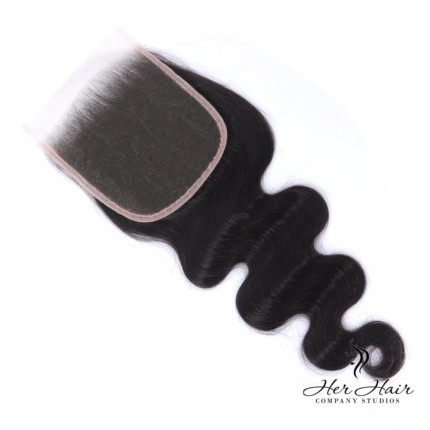 Brazilian Body Wave 5x5 HD Lace Closure by Her Hair Company showing close-up of natural wave pattern and lace details.