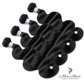 Four bundles of Brazilian Body Wave Hair from Her Hair Company, showcasing the luxurious, wavy texture in natural black hair.