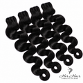 Four bundles of Burmese raw body wave hair from Her Hair Company, showing natural dark hair with soft waves.