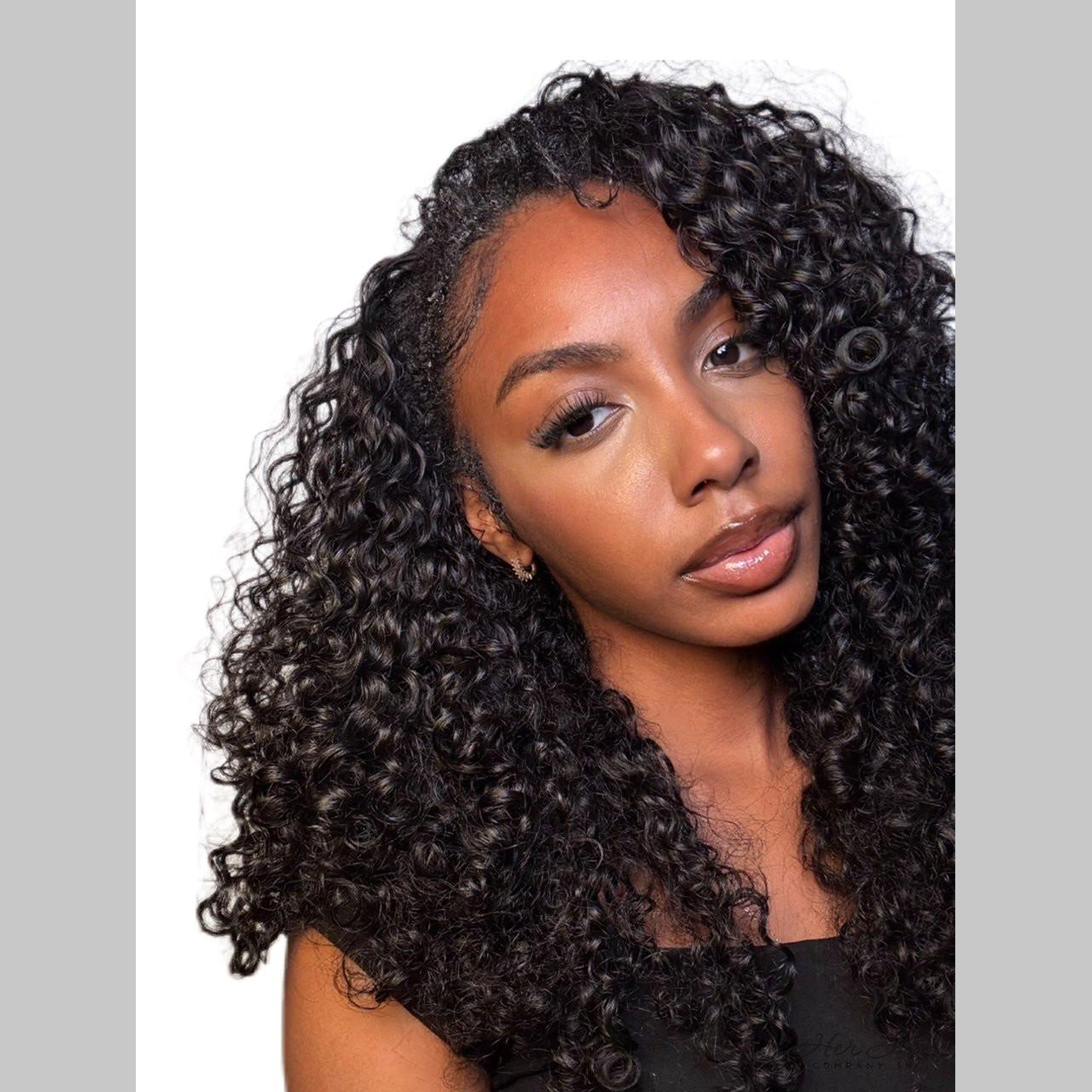 Close-up of Her Hair Company Brazilian Water Wave hair in a 4 bundle deal, showing the textured, wavy hair strands.