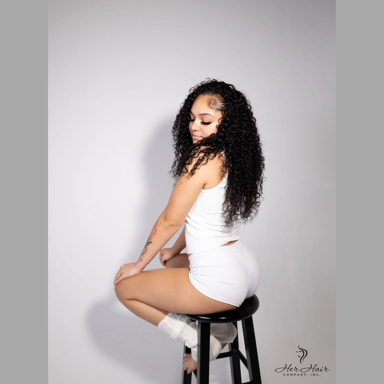 Side view of Brazilian Water Wave hair bundles from Her Hair Company, showing the natural water wave texture and bundle arrangement.