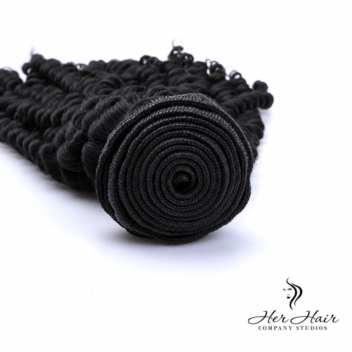 Brazilian kinky curly hair bundle from Her Hair Company showing detailed weft construction and natural kinky curl texture.