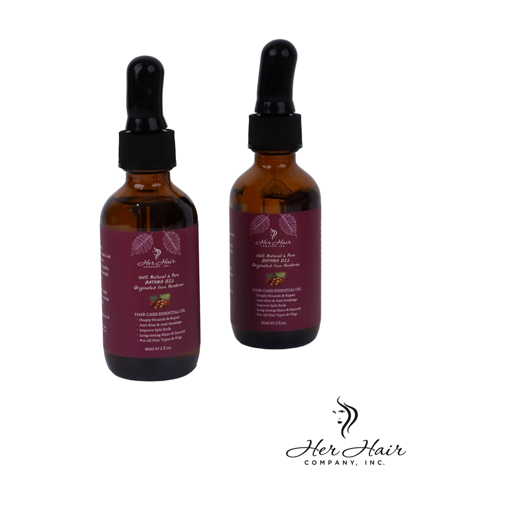 Two bottles of Honduran Batana Oil from Her Hair Company, 100% natural and authentic, with dark amber liquid inside clear glass bottles.