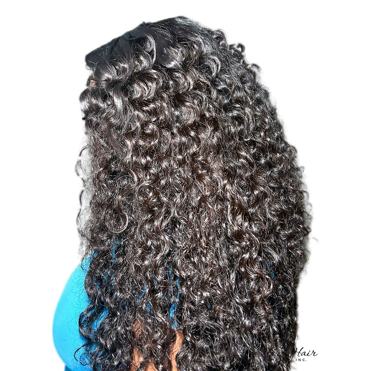 Side-back view of a model wearing a Burmese raw wavy hair bundle from Her Hair Company, showcasing natural wavy texture.