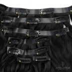 Full set of Brazilian Clip-In Premium Hair Extensions in a standard bundle, showcasing their natural, thick, and shiny hair strands.