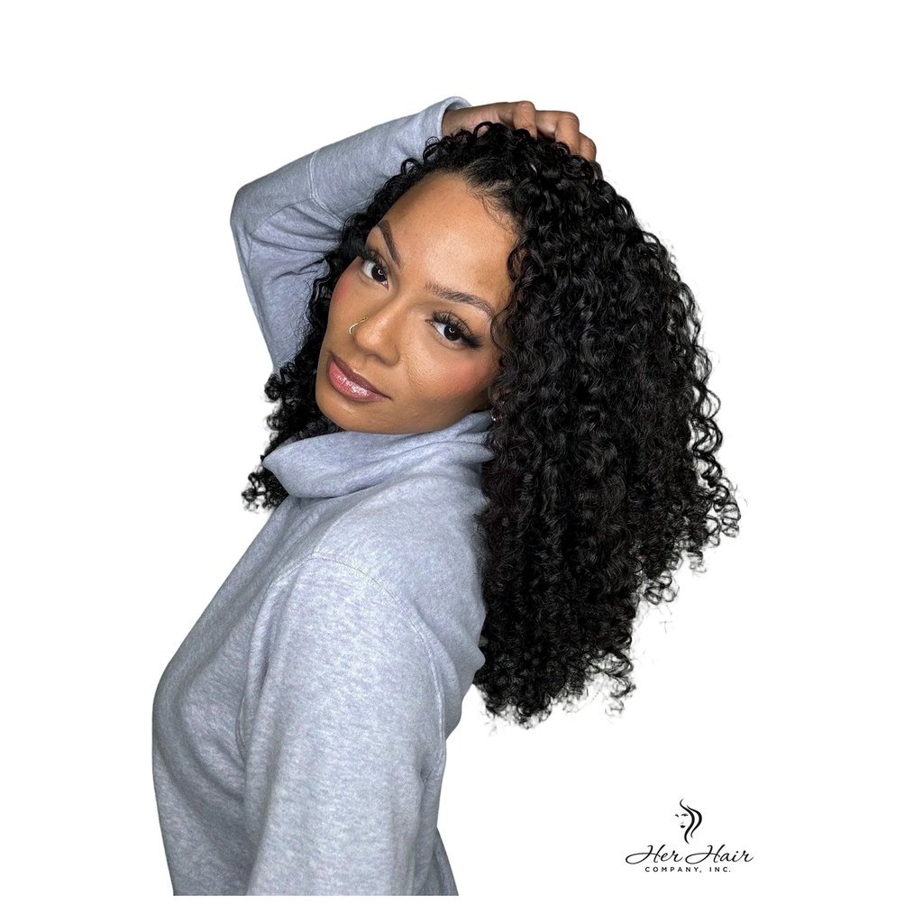 Burmese Spiral Crochet Hair Standard Bundle from Her Hair Company, installed over shoulder with gray top.
