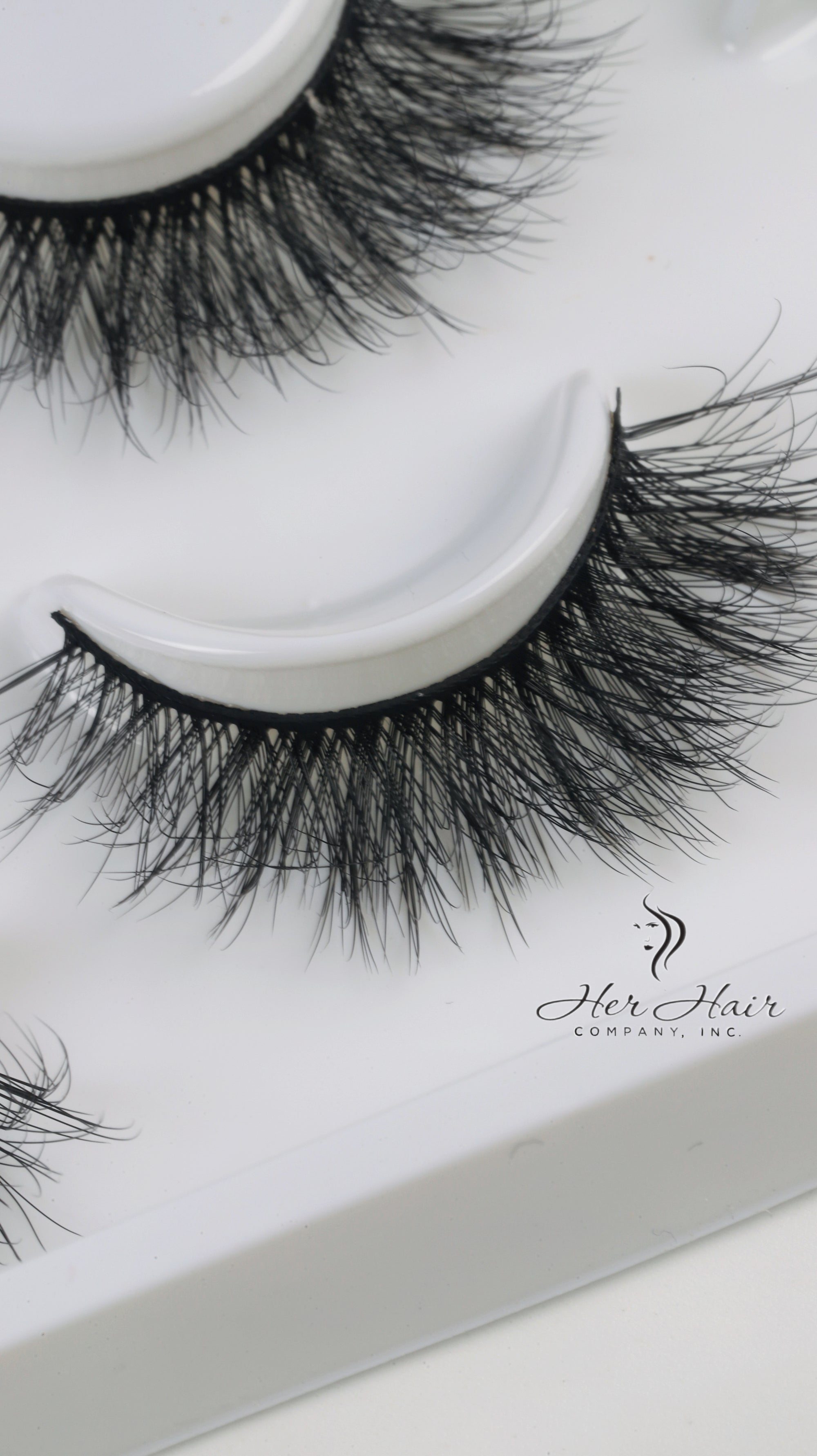 Her Hair Company false eyelashes, close-up view showing full, natural-looking eyelash strips for enhanced eye beauty.