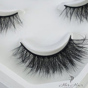 Her Hair Company false eyelashes with natural-looking lash extensions, showcasing full, fluttery eyelash designs.