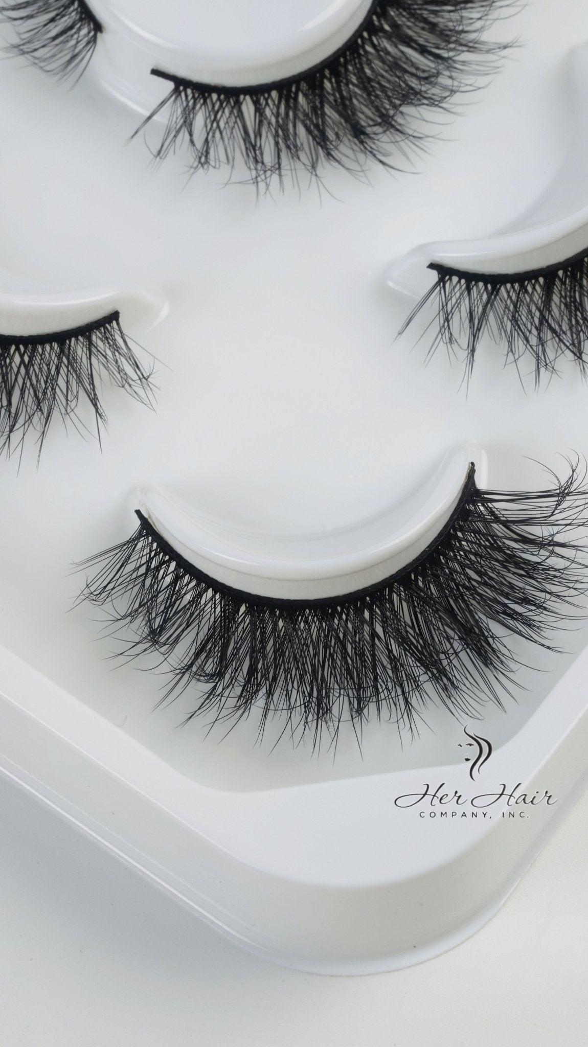 Her Hair Company false eyelashes with natural-looking lash extensions, showcasing full, fluttery eyelash designs.