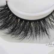 Her Hair Company eyelash extensions featuring natural, full lashes with a wispy style, perfect for a dramatic eye look.