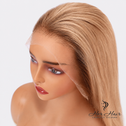 Honey blonde Swiss HD bob wig with dark roots from Her Hair Company, showcasing sleek, straight hair and natural volume.