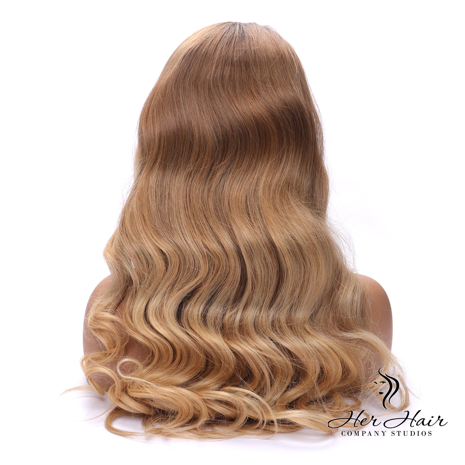 Honey blonde wig with dark roots, regular length, styled with soft waves, from Her Hair Company.