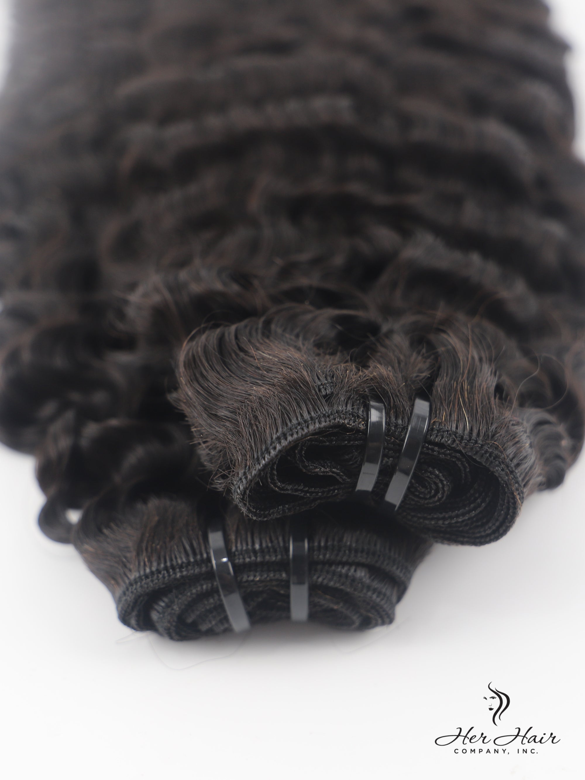 Burmese raw curly hair bundle from Her Hair Company, showing thick, natural curly hair texture in a standard bundle.
