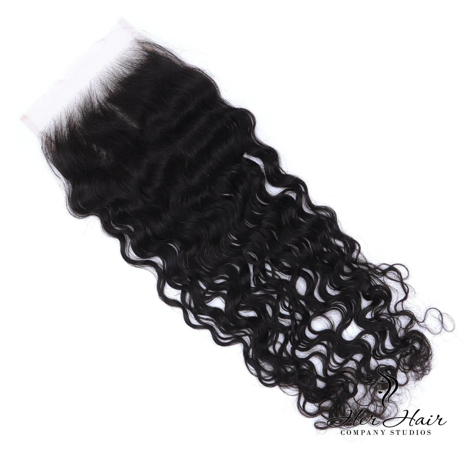 Brazilian raw wavy 5x5 HD lace closure from Her Hair Company, showing close-up of natural waves and lace details.