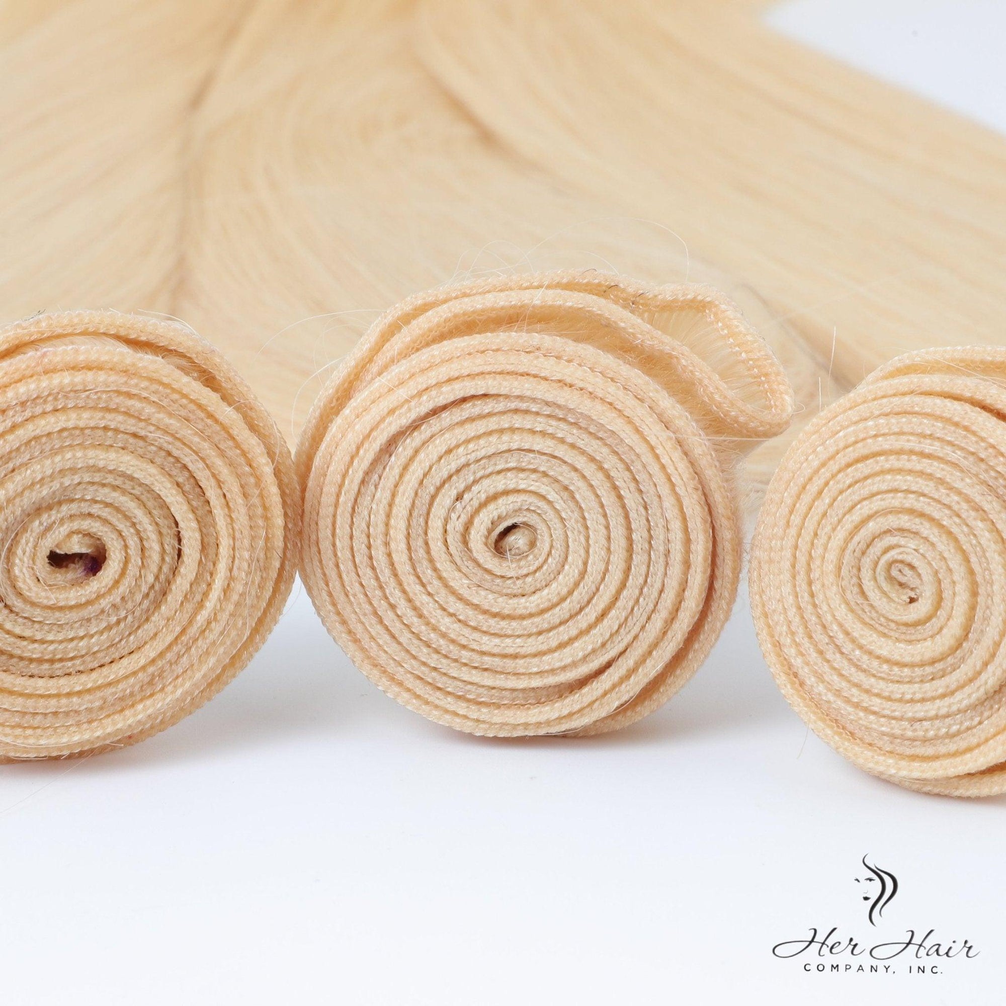 Three bundles of Brazilian 613# hair in a standard bundle deal, showcasing light blonde, straight hair extensions.