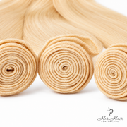 Three bundles of straight Brazilian 613# hair from Vendor-Unknown, showcasing the lightweight, silky blonde hair bundles.